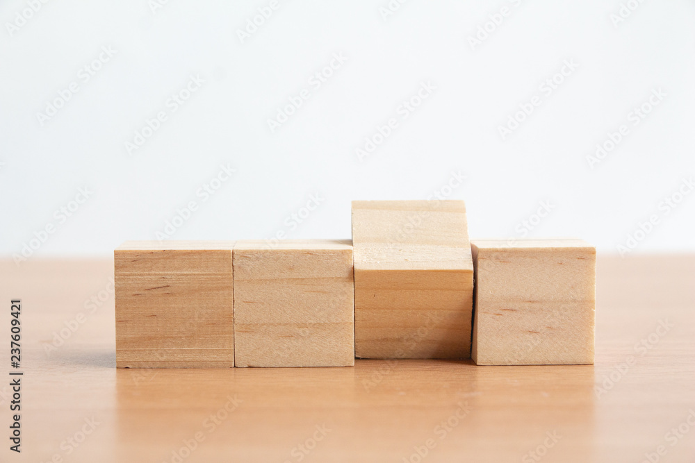 Wooden cube on wood table.