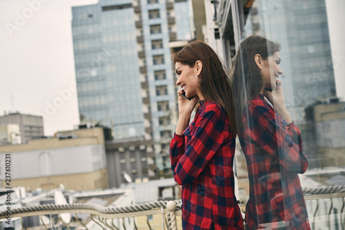 Smiling young woman is locating on terrace