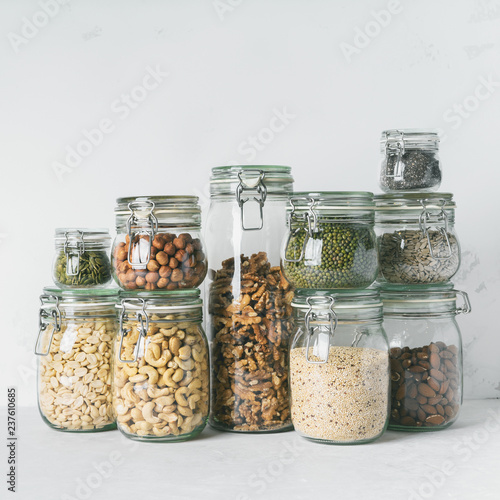 Glass jars with Superfoods nuts and cereals stacked on top of each other