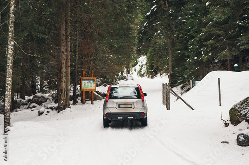 Scenic veiw of empty road with snow landscape and car