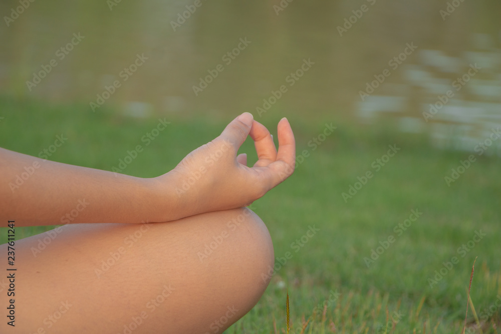 Woman practicing meditating in nature at the park.Health lifestyle, mind body improvements concept. Woman practicing meditating in nature at the park.Health lifestyle, mind body improvements concept.