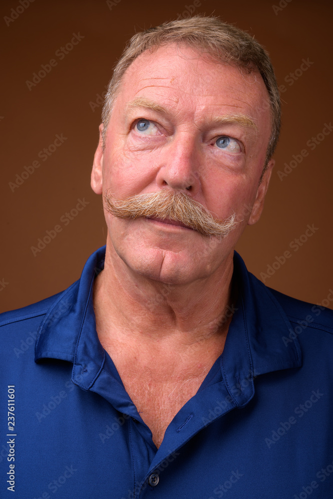 Face of handsome senior man with mustache thinking Face of handsome senior man with mustache thinking