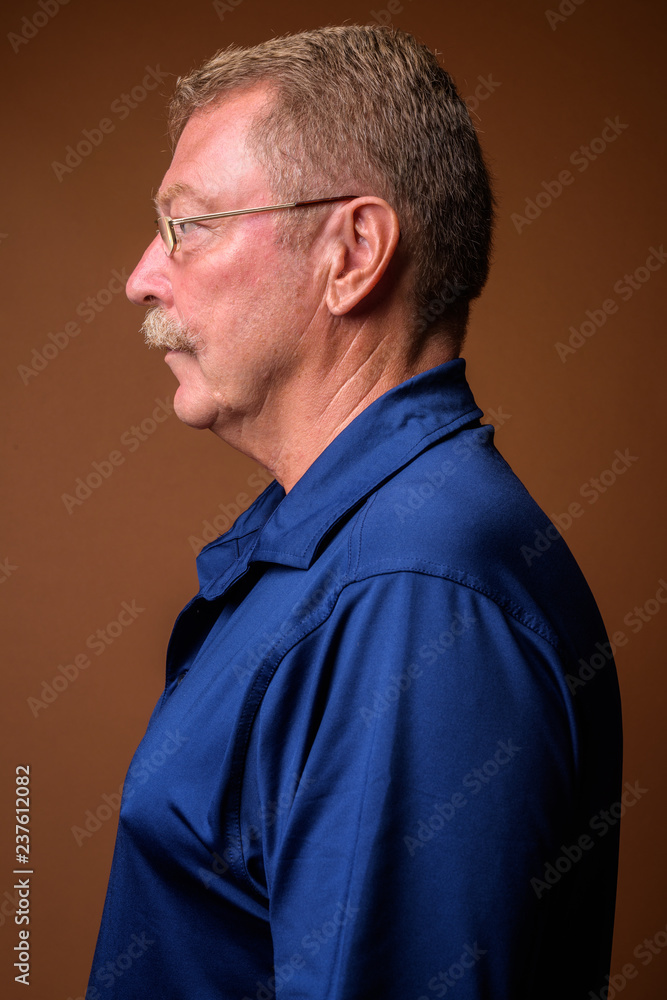 Profile view portrait of handsome senior man with mustache wearing eyeglasses Profile view portrait of handsome senior man with mustache wearing eyeglasses