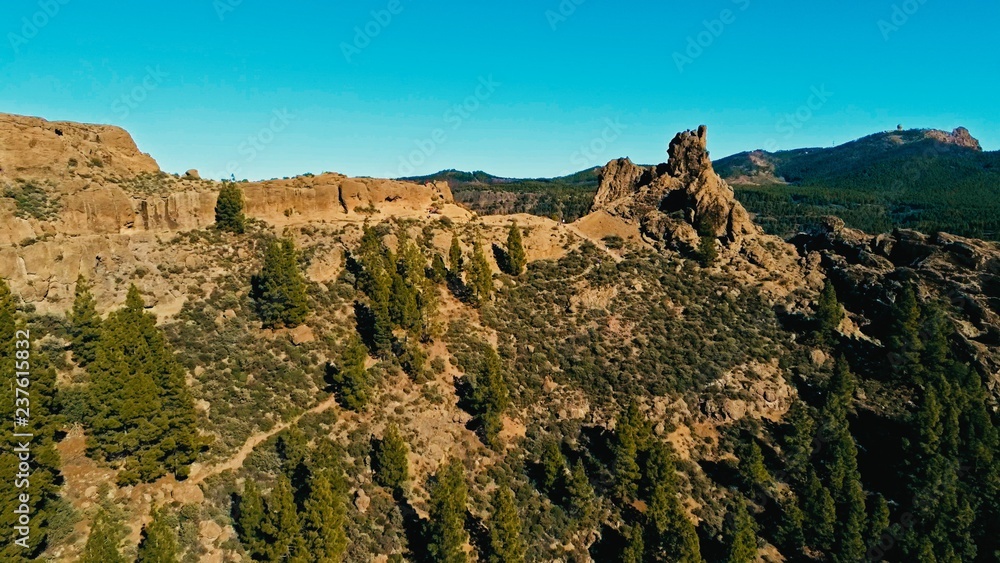 aerial drone image of beautiful stunning landscape view off the Roque Nublo rock formation and plateau at Gran Canaria Spain with a valleys and many small peaks on a sunny day