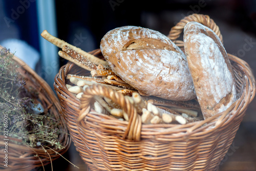 Bread loaves and baguettes in a wicker basket.