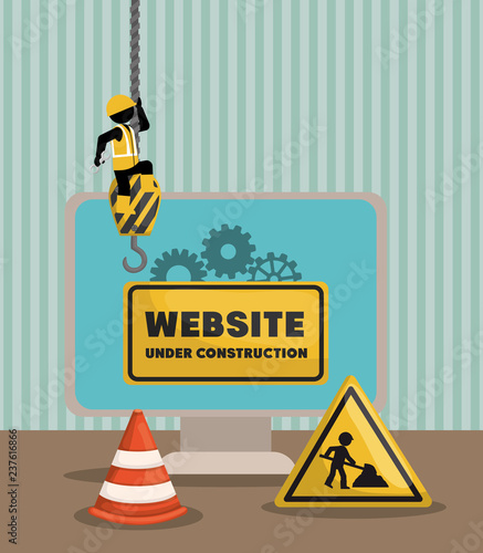 website under construction with desktop computer