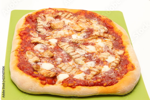 Homemade pizza with chicken on green board , isolated