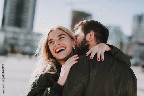 Charming young lady enjoying romantic date with her boyfriend
