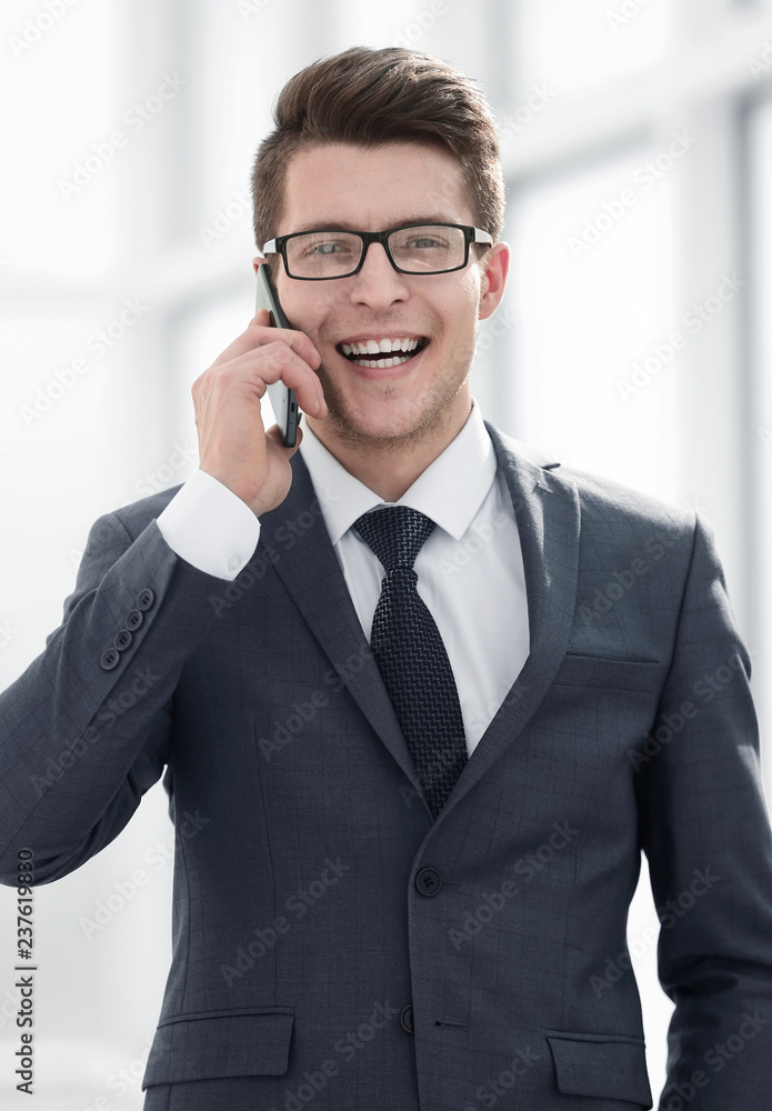 smiling young businessman talking on smartphone smiling young businessman talking on smartphone