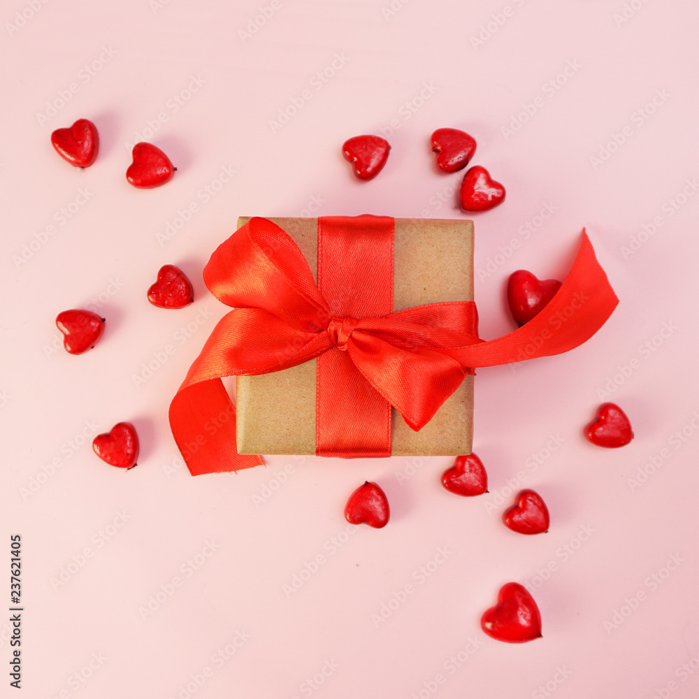 Gift box with red bow ribbon and paper heart on wooden table for Valentines day. Gift box with red bow ribbon and paper heart on wooden table for Valentines day.