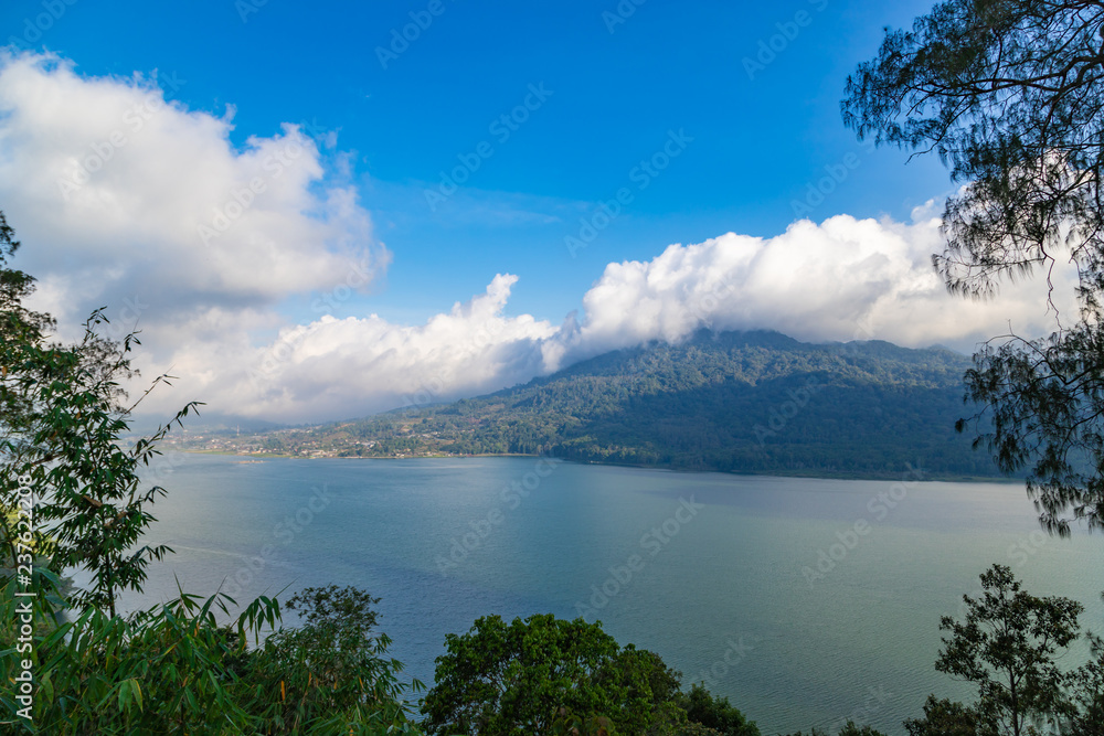 Lake Buyan,caldera lake at Bali. Beautiful lake with turquoise water in the mountains of the island of Bali. Landscape, lake among mountains, sky, clouds.