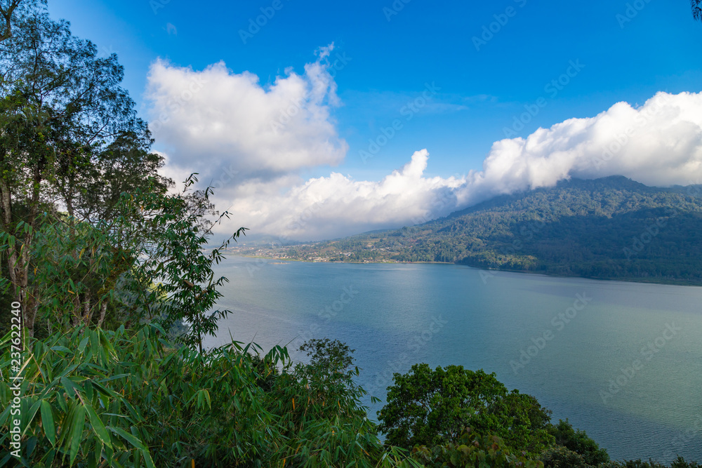 Lake Buyan,caldera lake at Bali. Beautiful lake with turquoise water in the mountains of the island of Bali. Landscape, lake among mountains, sky, clouds.