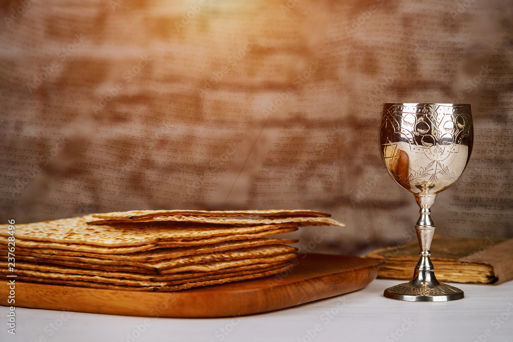 Fototapeta premium Passover holiday concept with wine and matzoh over rustic background with copy space