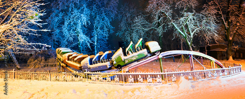 Snow-covered attractions in the old park