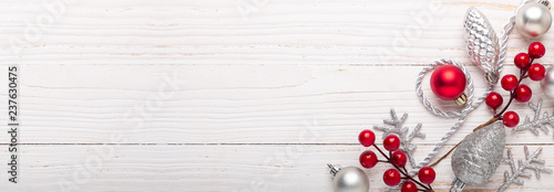 Silver and red christmas gifts on white wooden background. Top view. Copy space. Long banner