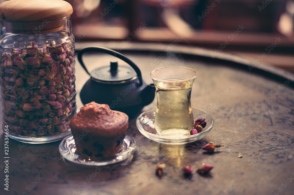 rose tea and flower in the pot with muffin and bokeh rose tea and flower in the pot with muffin and bokeh