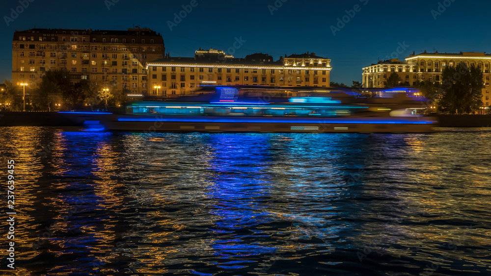 view of illuminated night river , embankment and the movement of river vessels view of illuminated night river , embankment and the movement of river vessels