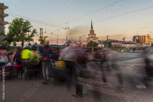 silhouettes of people waiting for a traffic light signal