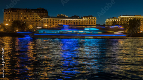view of illuminated night river , embankment and the movement of river vessels