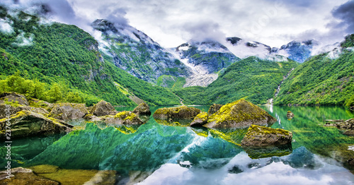 Amazing lake on a background of mountains and glacier. Norway. Beautiful landscape. Artistic picture. Beauty world.
