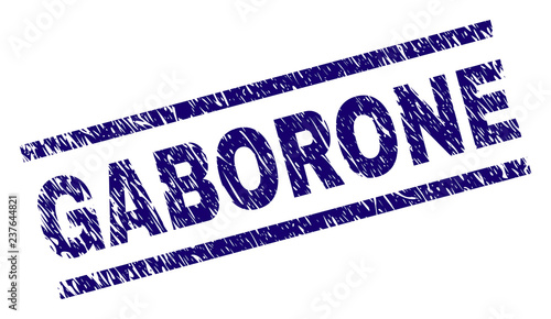 GABORONE seal print with distress style. Blue vector rubber print of GABORONE tag with unclean texture. Text tag is placed between parallel lines.