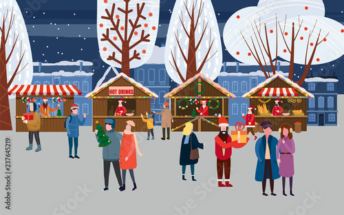 Christmas market or holiday outdoor fair on town square. People walking between decorated stalls, canopy or kiosks, buying snacks,gifts, decoration and drinking hot coffe, tea and mulled wine