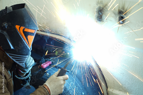 Man welding in protective mask.