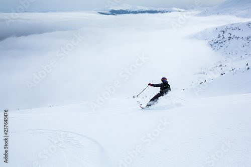 A woman is skiing on the slope.