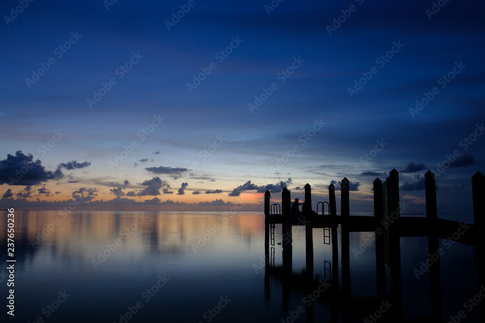 Dusk falls over the Gulf of Mexico in the Florida keys with beautiful skies and calm ocean waters
