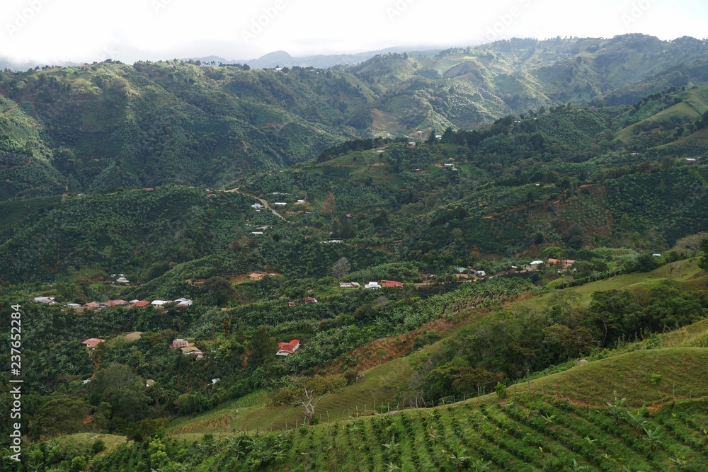 A view of colorful houses and lugh vegetation hight in Costa Roca mountains