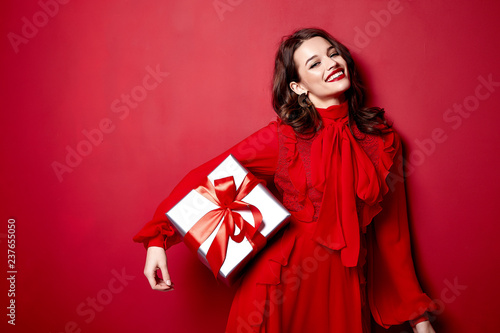 Beautiful young sexy woman thin slim figure evening makeup fashionable stylish dress clothing collection, brunette, gifts boxes red silk bows holiday party birthday New Year Christmas Valentine's Day.