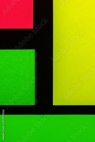 Green, yellow and rose hue colorful office stickers on black paper. Office noteparer as reminder. Isolated on black paper.