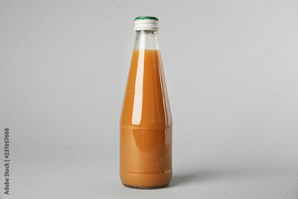 One bottle with tasty drink on color background One bottle with tasty drink on color background