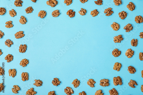 Flat lay composition with tasty walnuts and space for text on color background