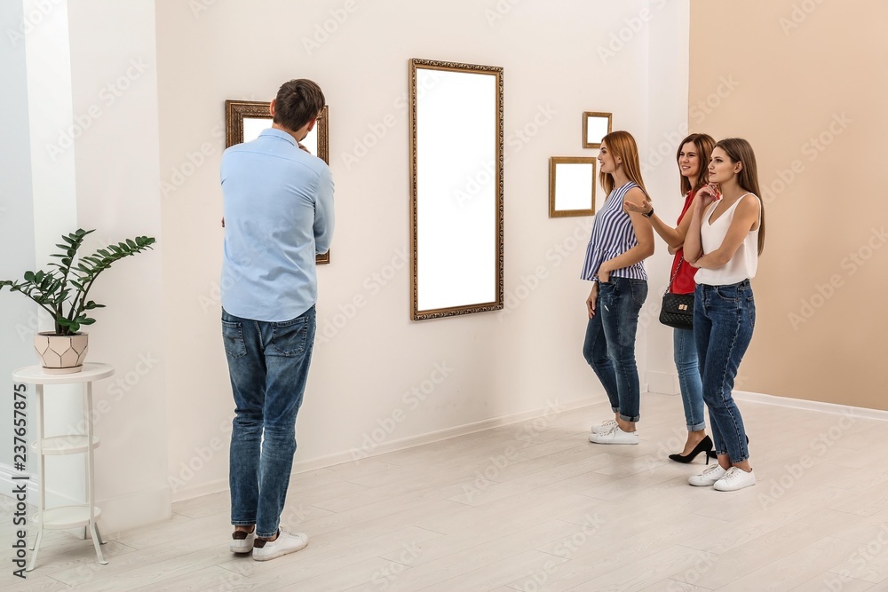 People viewing exposition in modern art gallery People viewing exposition in modern art gallery