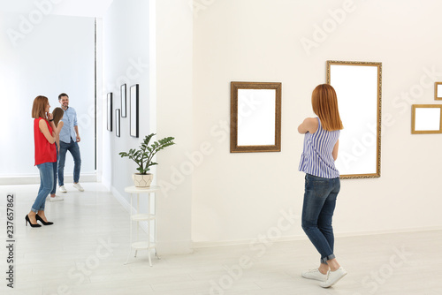 People viewing exposition in modern art gallery