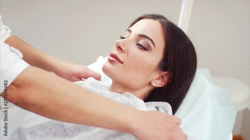 Young attarctive woman is got prepared for cosmetical procedure in beauty clinic