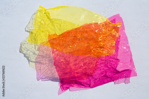 Φωτογραφία Thin sheet of multi coloured cellophane with shiny crumpled surface texture  on