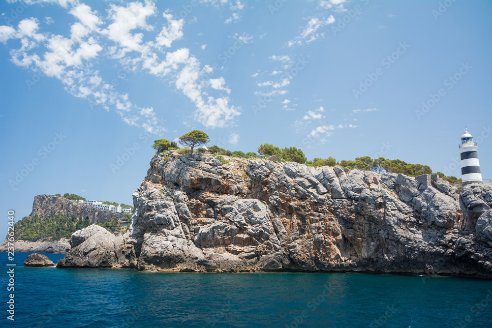 Port de Soller, Mallorca, Spain - July 19, 2013: View of the lighthouse and defenses in Soller Bay