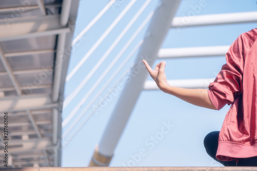 Asian woman having yoga and meditation outdoor in city