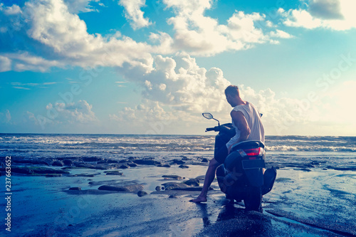 Man on the motorbike on the beach