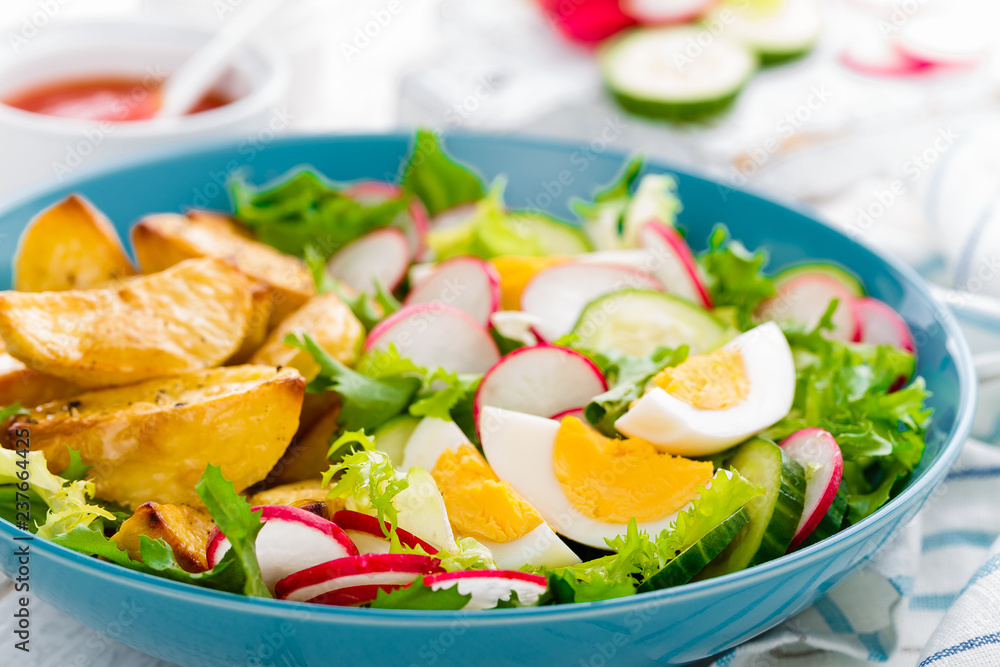 Delicious baked potato, boiled egg and fresh vegetable salad of lettuce, cucumber and radish. Summer menu for detox diet Delicious baked potato, boiled egg and fresh vegetable salad of lettuce, cucumber and radish. Summer menu for detox diet