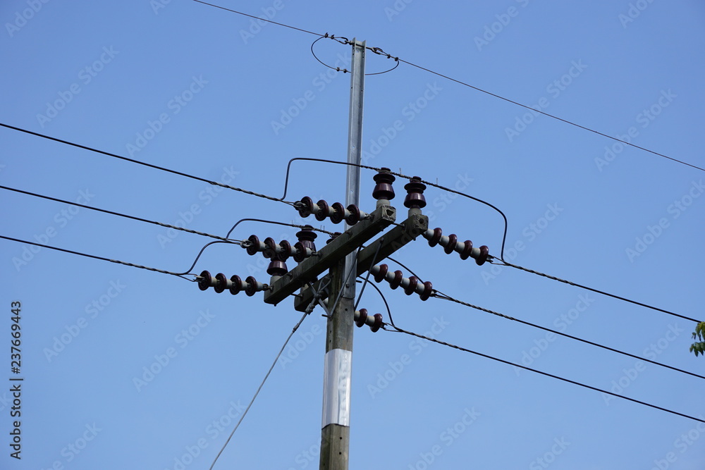 Electricity transmission line and electric pole on blue sky background. Electricity transmission line and electric pole on blue sky background.