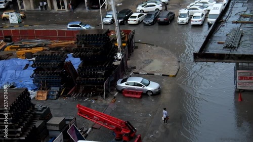 Flooded street and construction sight with cars parked submerged in muddy flood waters in Al Nahda, Sharjah, United Arab Emirates after a heavy rain on November 26, 2018 photo