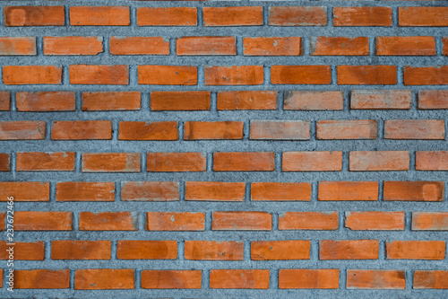 Red brick wall fragment background or brick layer building texture.