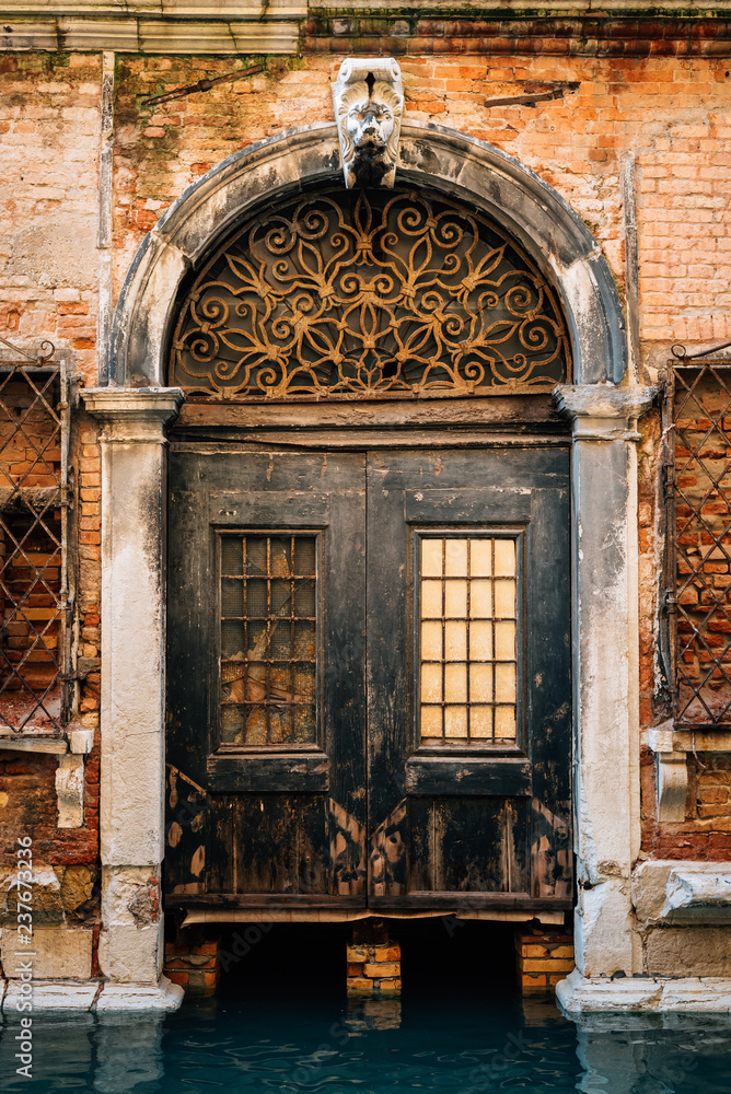 A door along a canal, in Venice, Italy