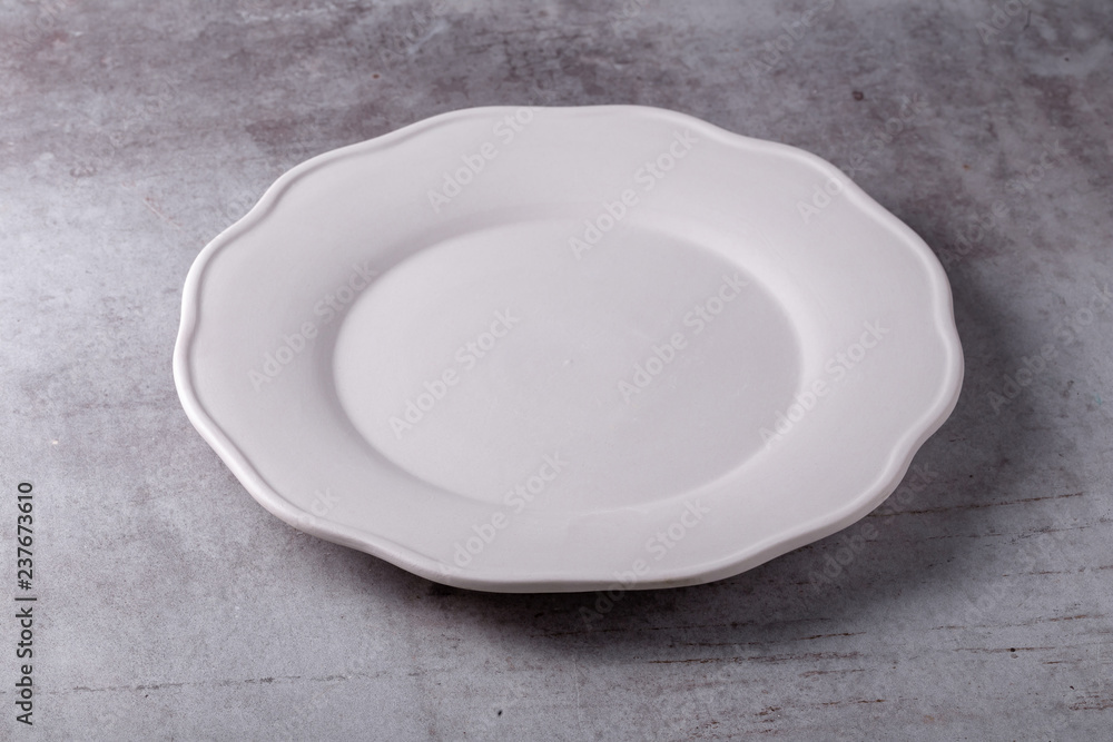 Empty blank white ceramic dish on Cement Board Empty blank white ceramic dish on Cement Board