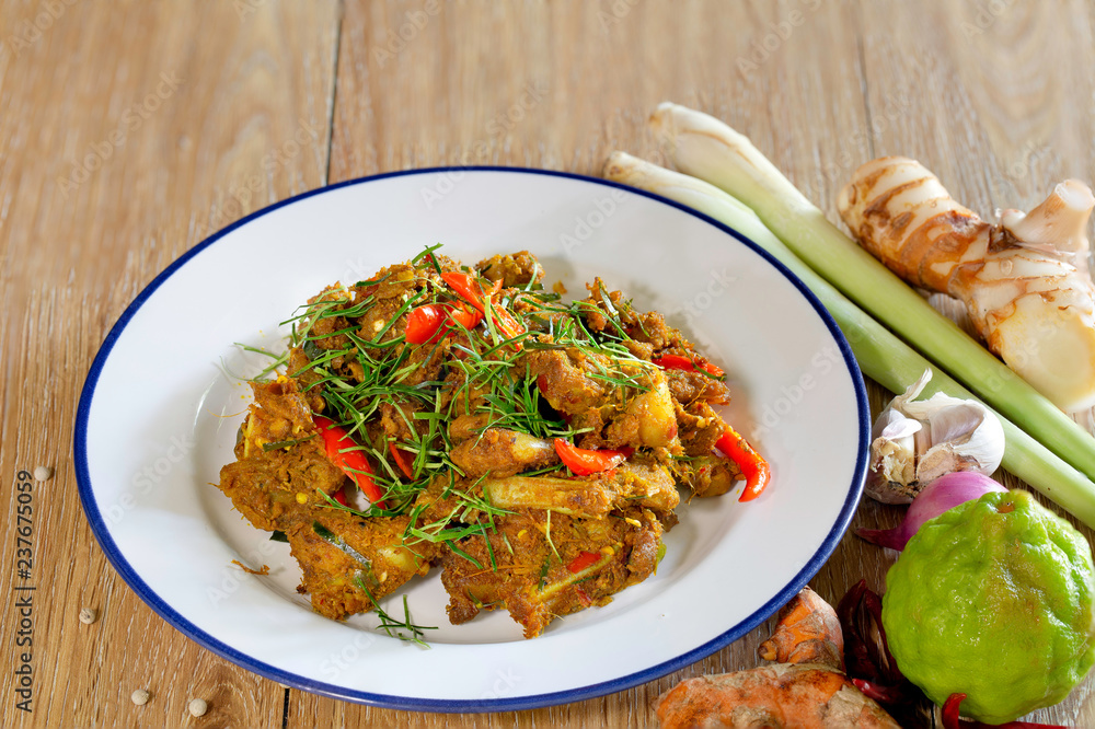 Stir fried cartilage pork with spicy curry paste (Thai call *Kua Kling*) thai food, in white dish Stir fried cartilage pork with spicy curry paste (Thai call *Kua Kling*) thai food, in white dish