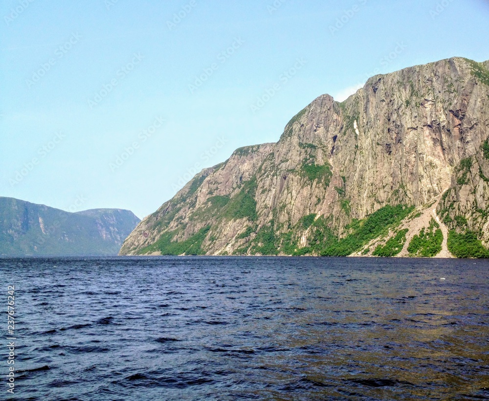 Admiring the beautiful view from the tour boat at the fjords of the Western brook pond in Gros Morne National Park, Newfoundland and Labrador, Canada Admiring the beautiful view from the tour boat at the fjords of the Western brook pond in Gros Morne National Park, Newfoundland and Labrador, Canada
