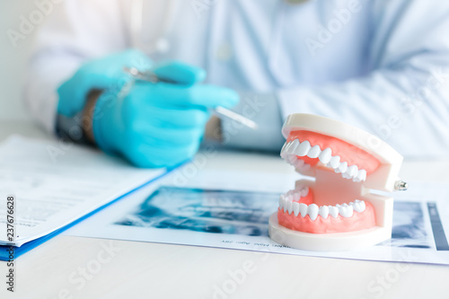 Close up dentures with dentist working on table in clinic. photo